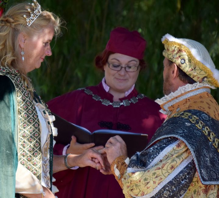 Roxanne in Tudor costume blessing a couple's rings
